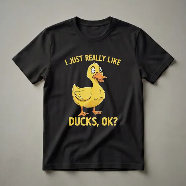 Black t-shirt with a yellow cartoon duck and yellow text that reads 'I JUST REALLY LIKE DUCKS, OK?'.