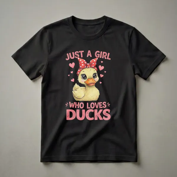 Black t-shirt featuring a cute cartoon duckling wearing a red polka dot bandana and bow, surrounded by pink hearts, with the text 'JUST A GIRL WHO LOVES DUCKS' in pink lettering.