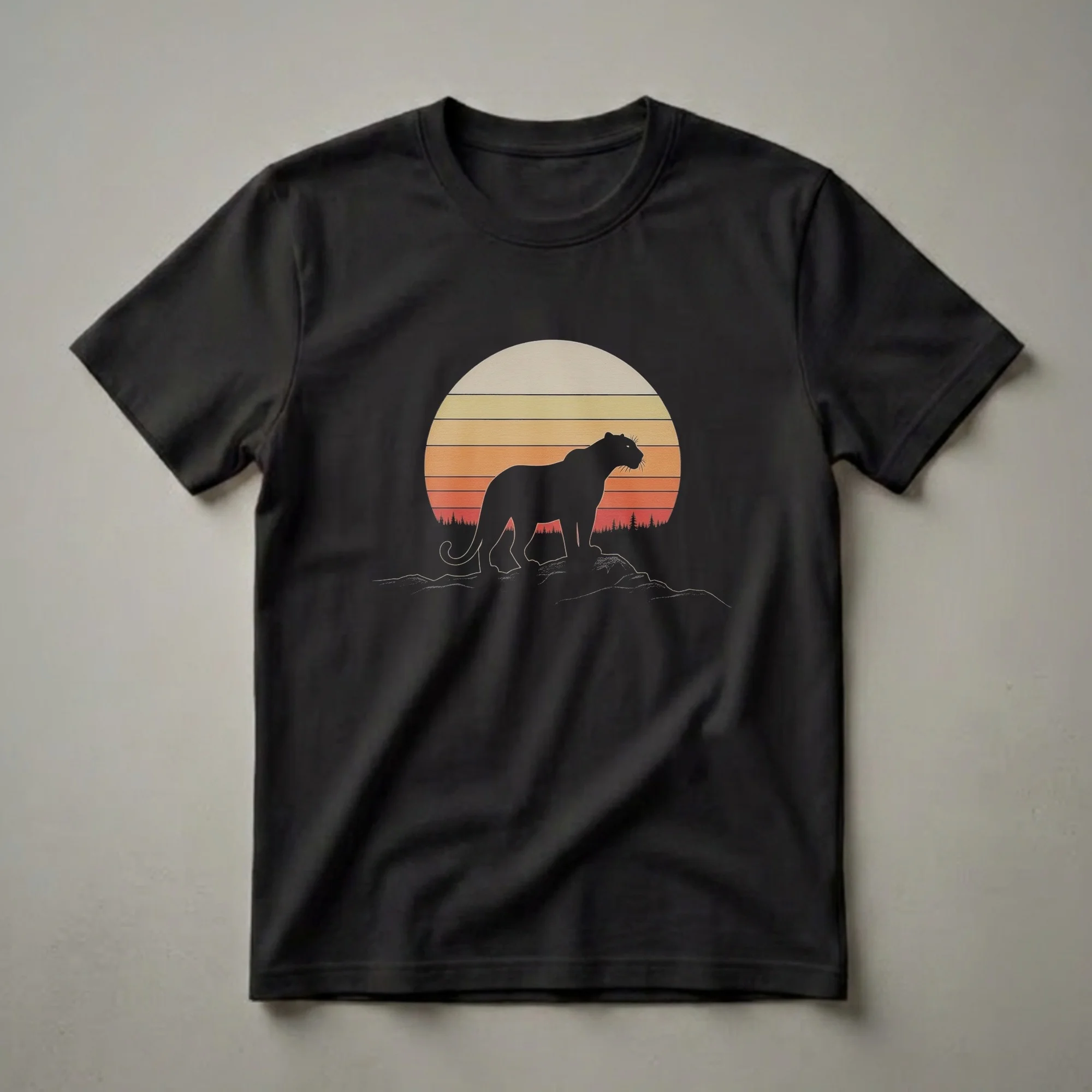 Black panther silhouette standing on rocks against a retro sunset with orange and yellow stripes and a pine tree forest silhouette, on a black t-shirt.