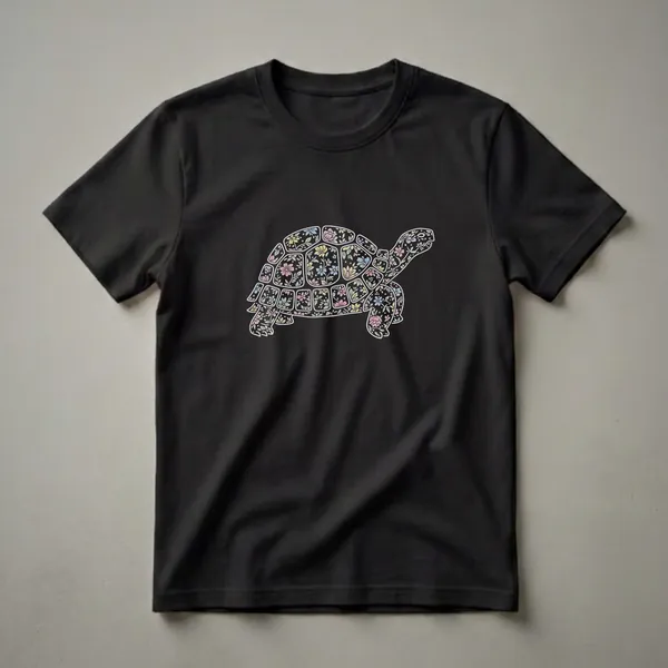 Black t-shirt featuring a side profile of a tortoise filled with a vintage-style floral pattern in pastel colors, outlined in white.