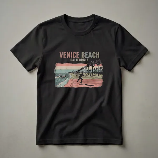 Black graphic t-shirt featuring a retro illustration of Venice Beach, California, with a skateboarder on the boardwalk, palm trees, and ocean waves.