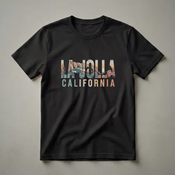 Black t-shirt featuring a retro graphic design with the words LA JOLLA CALIFORNIA filled with a coastal scene of waves, cliffs, seaweed, and sea lions.