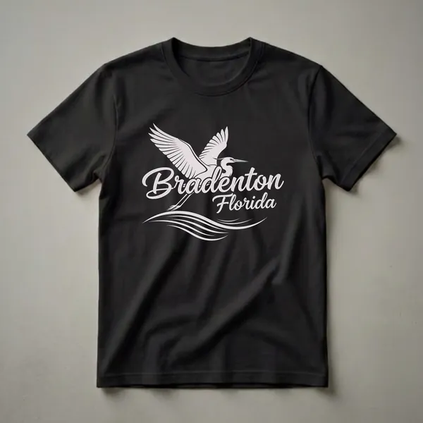 Black t-shirt featuring a white graphic design of a flying egret above wavy lines, with the text 'Bradenton Florida' in script.
