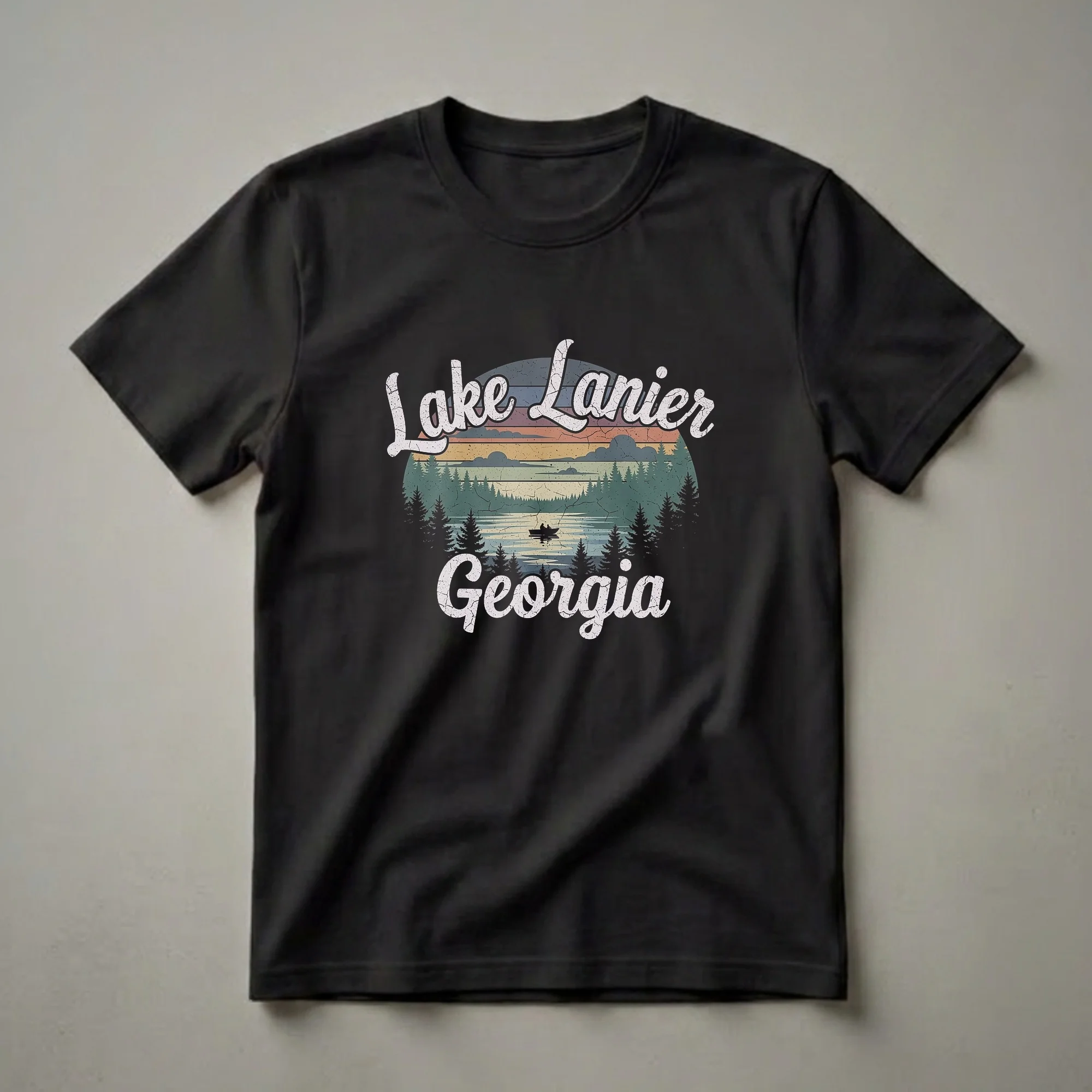 Black t-shirt with a retro graphic design of Lake Lanier, Georgia, featuring a sunset, pine trees, and a boat with two people fishing on the water.