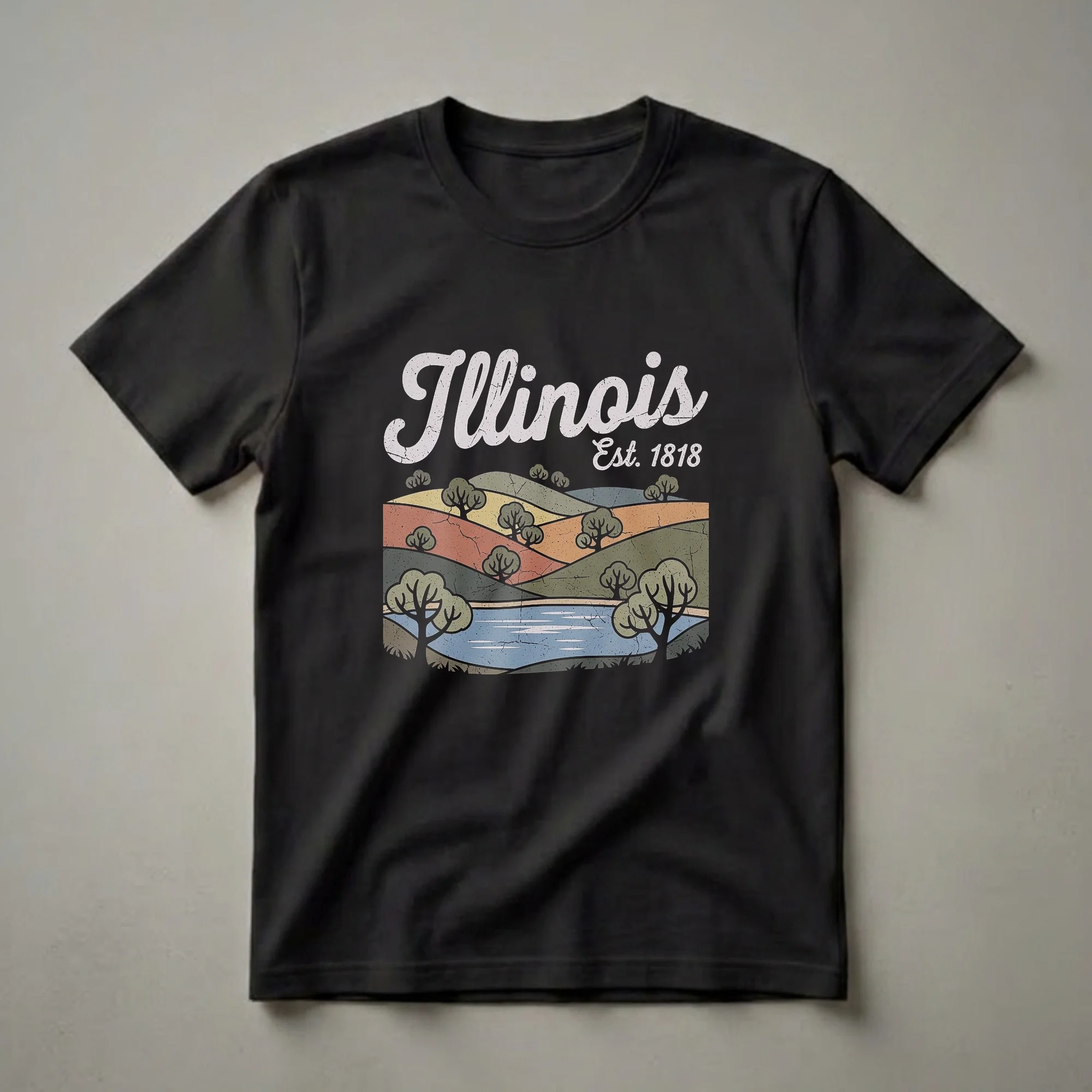 Black t-shirt featuring a retro graphic of rolling green and orange hills, trees, and a blue body of water, with the text 'Illinois Est. 1818' in a distressed font.