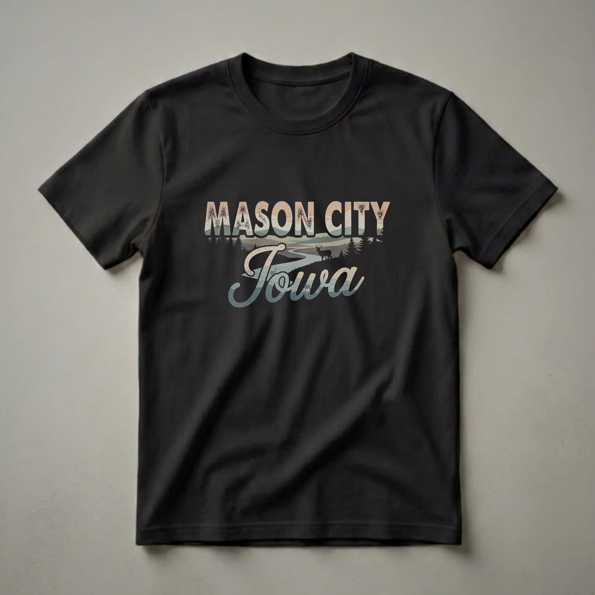 Black t-shirt with retro graphic design for Mason City, Iowa, featuring distressed text and a scenic landscape with deer and a river.