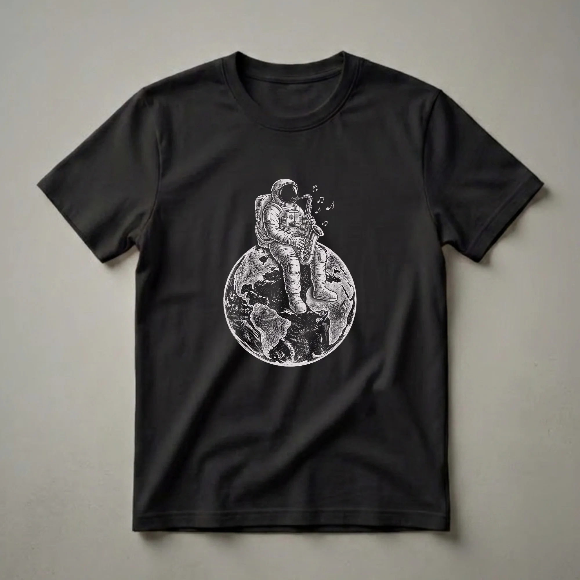 Black and white graphic t-shirt featuring an astronaut in a spacesuit playing a saxophone while sitting on the planet Earth, with musical notes depicted in the air.