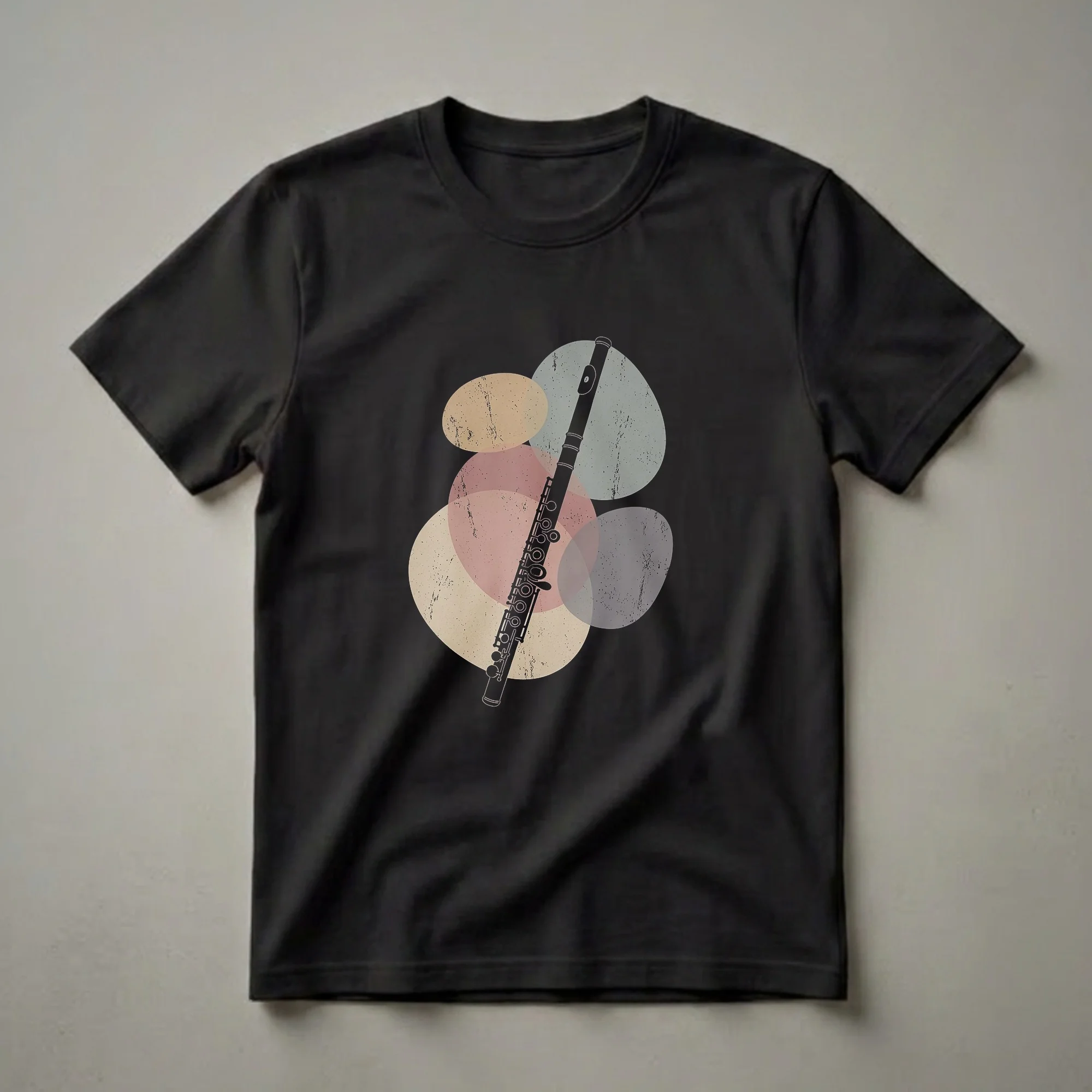 Black silhouette of a flute with detailed keys, overlaid on abstract, textured oval shapes in beige, pink, and grey, on a black t-shirt.