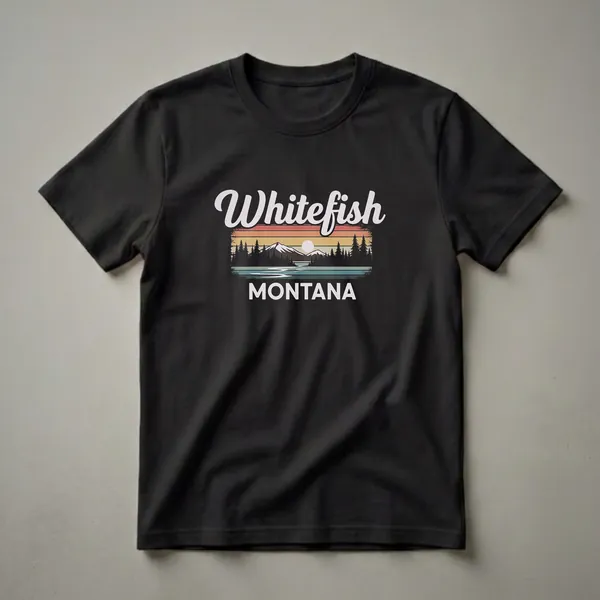 Black t-shirt with a retro graphic design featuring the words "Whitefish Montana" over a sunset landscape with mountains, pine trees, and a lake.